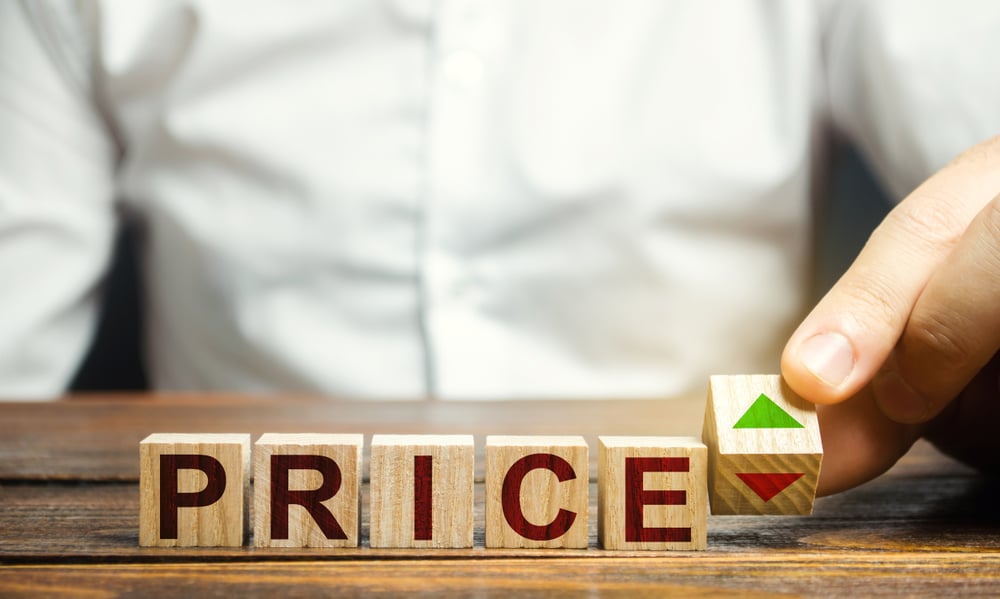 Wooden blocks spelling out "Price" with final block showing red and green arrows.