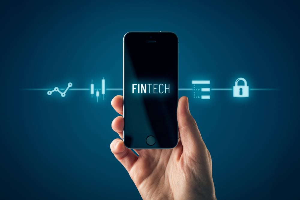 Hand holding smartphone with word "Fintech" displayed