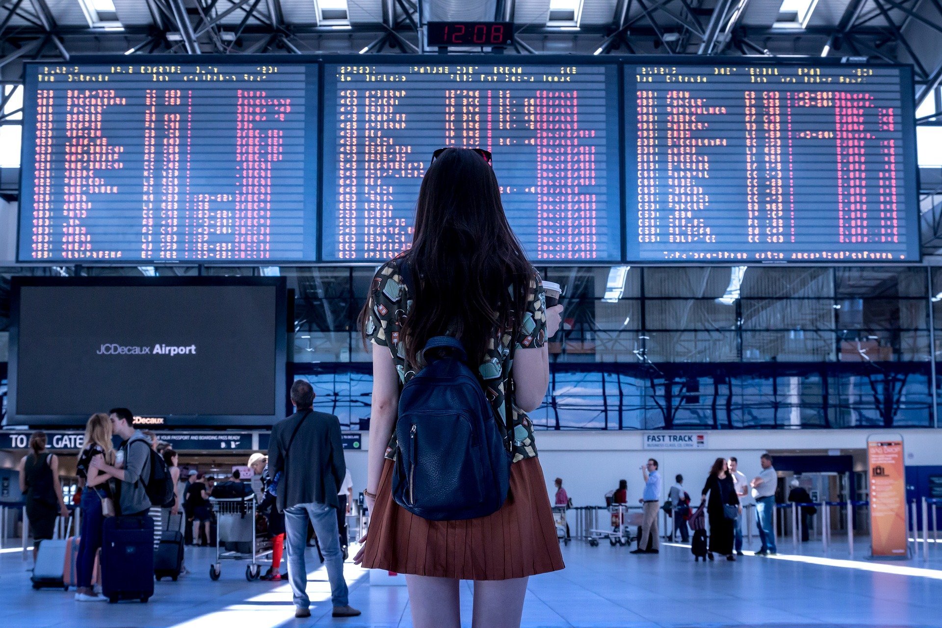 A woman stands in an airport.