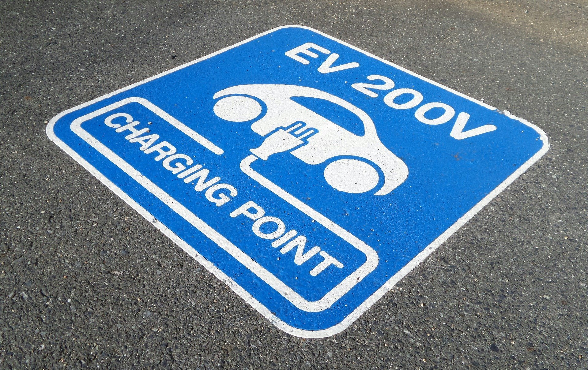 A sign identifies an electric vehicle charging location..