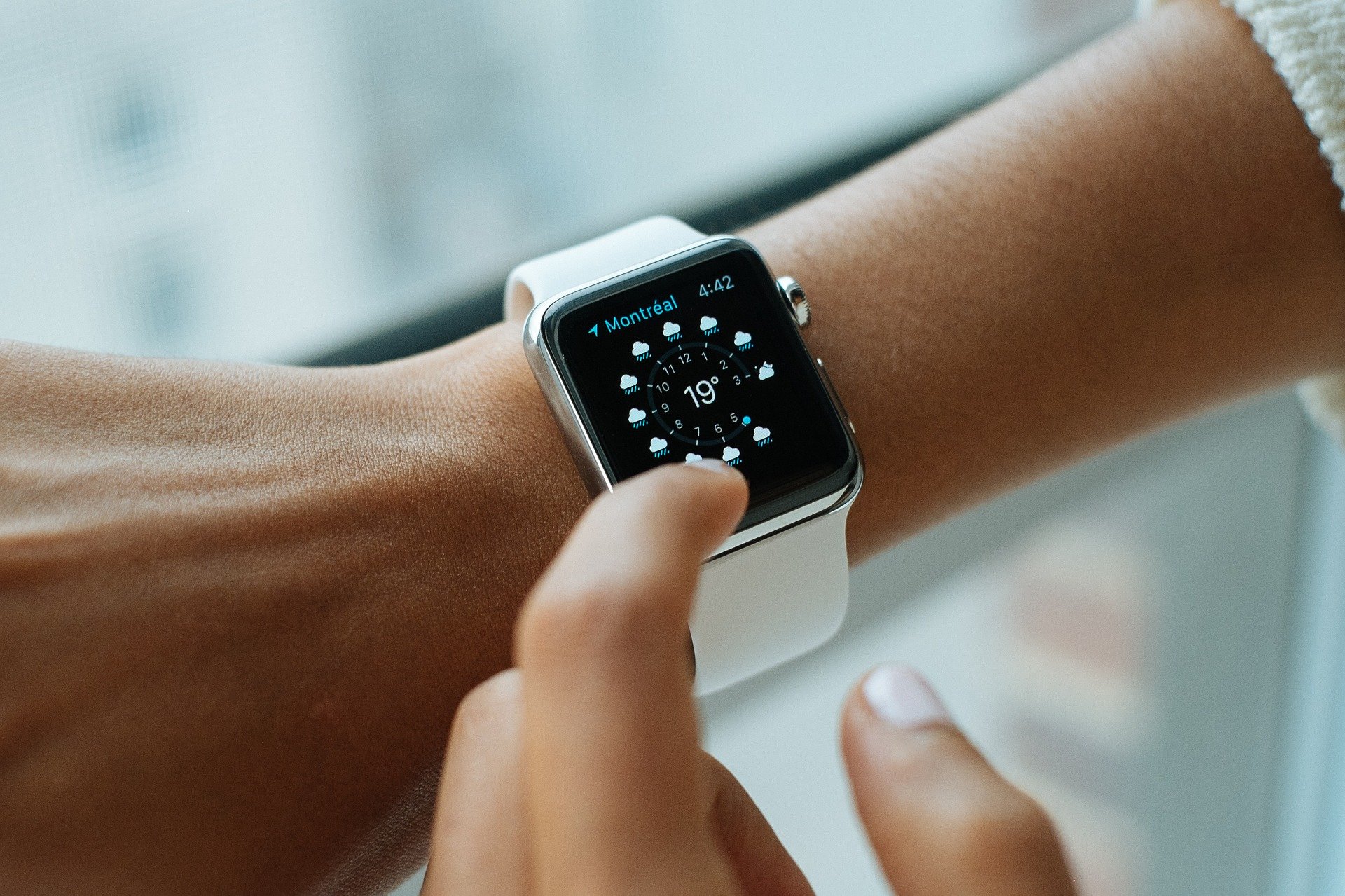 A person wears an Apple wqtch.