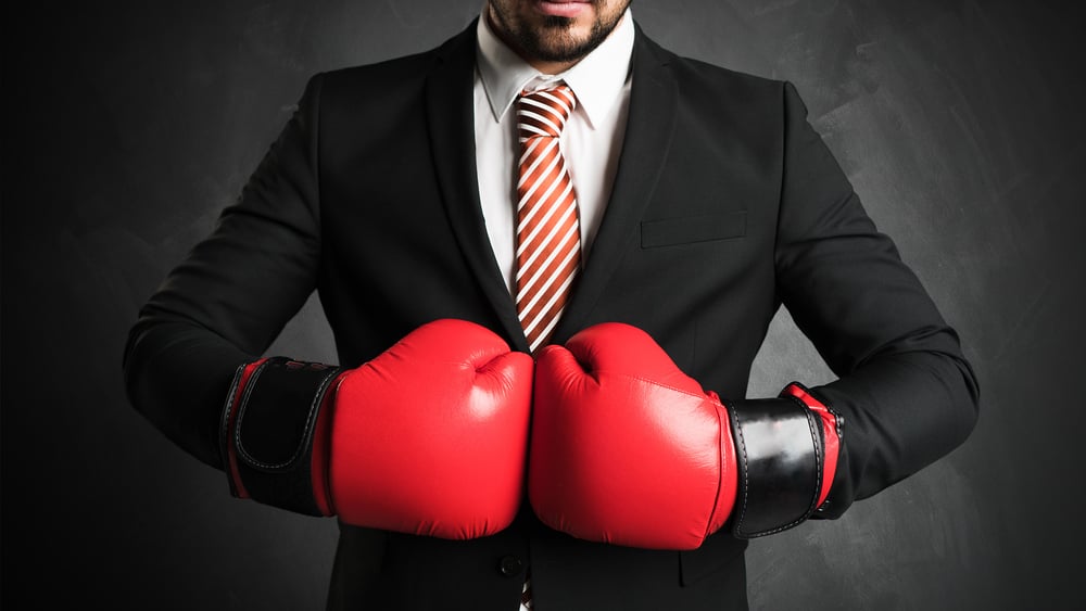 A businessman with boxing gloves.