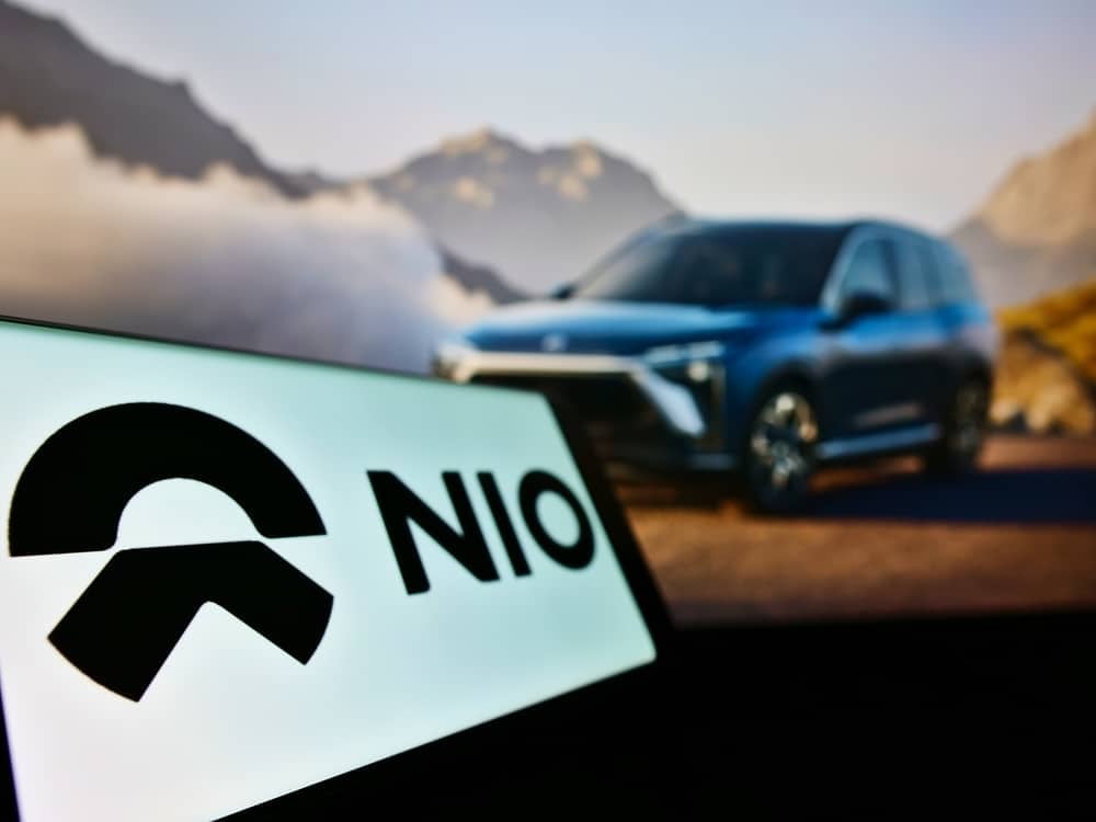 An sign that reads "NIO" in front of one of its electric SUV vehicles